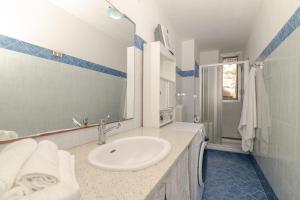 a bathroom with a sink and a mirror at Casa Flock in La Maddalena +13 photos