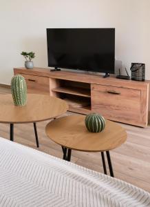 a living room with two tables and a flat screen tv at La casa de Samuel y Laia in Costa Calma