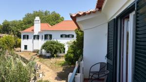 a view of a white house from a balcony at Estalagem De Colares in Sintra
