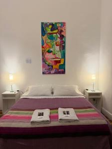 a bedroom with a bed with a painting on the wall at Balcones de Cabrera in Buenos Aires