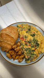 a plate of food with an omelet and bread at Estalagem De Colares in Sintra