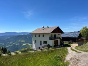 a house with solar panels on top of a hill at greenlodge pornplatthof in Auna di Sopra