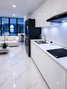 a white kitchen with a sink and a couch at NIDO Boutique Hotel in Quito