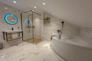 a bathroom with a tub and a shower and a sink at Dorijini Dvori in Baška Voda +30 photos