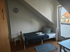 a small bed in a room with a staircase at Revant Monteurzimmer Haus in Arnstadt
