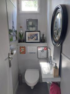 a small bathroom with a toilet and a sink at Chambres sur Seine Megalight2 in Sèvres