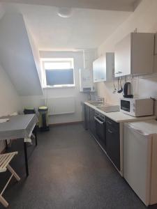 a kitchen with a sink and a table in it at Revant Monteurzimmer Haus in Arnstadt