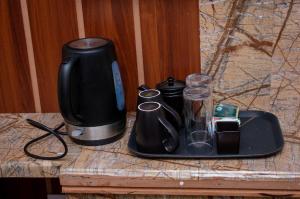 a counter with a coffee maker and a blender at Hillpark Hotel in Eldoret