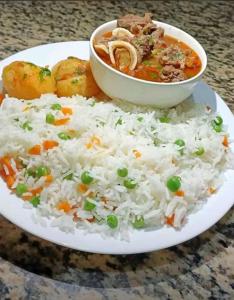a plate of rice and a bowl of soup at Hillpark Hotel in Eldoret