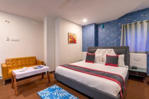 a bedroom with a large bed and a table at ABI RESIDENCY Hitech City in Hyderabad