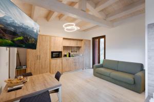 a living room with a table and a couch at B&B La Tana in Belforte del Chienti