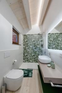 a bathroom with a toilet and a sink at B&B La Tana in Belforte del Chienti