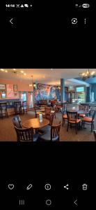 a restaurant with tables and chairs and a mural at Steeple Bay E68 in Steeple