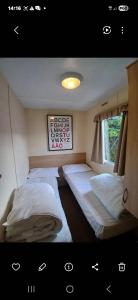 a bedroom with two beds and a window at Steeple Bay E68 in Steeple +16 photos