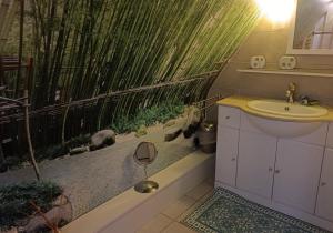a bathroom with a toilet and a sink and a bamboo at La Coccinelle Des Caps in Ambleteuse +40 photos