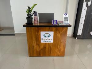 a wooden desk with a laptop on top of it at RoyalNest Gardenia in Belgaum