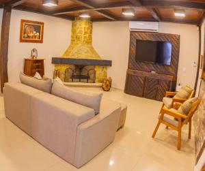 a living room with a couch and a fireplace at Solarium Da Represa in Santa Branca