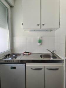 a kitchen with a sink and a counter top at Studio 3 lits in Saint-Louis +1 photo