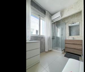 a bathroom with a shower and a sink and a mirror at Pasarla rico in Torreblanca +42 photos