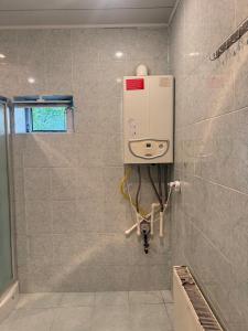 a bathroom with a soap dispenser on the wall at Gabala mountain house in Gabala +3 photos