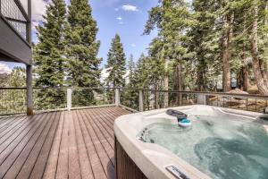 a hot tub on a wooden deck with trees at Orion Ridge Retreat in Stateline