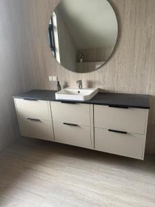 a bathroom with a sink and a mirror at ScenicOceanview 4Free parking space 18 mins Downtown in Álftanes +16 photos