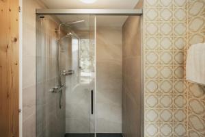 a shower with a glass door in a bathroom at Hôtel du Glacier in Champex +31 photos