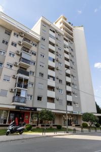 a motorcycle parked in front of a building at Lumi Apartment in Podgorica