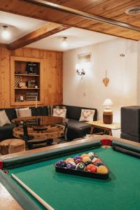 a living room with a pool table at Hôtel du Glacier in Champex