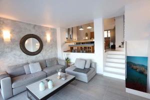 a living room with a couch and a table at Villa Lina Syros in Azolimnos Syros