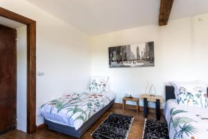 a bedroom with a bed and a bed and a table at Domaine Cherps Spa - Sérénité in Vielleségure +13 photos