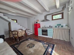 a kitchen with a red refrigerator and a table at Locazione del cavaliere in Fano +7 photos