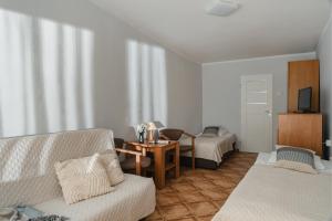 a living room with a couch and a table at Rewita Pieczyska in Koronowo