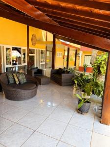 a living room with couches and plants on a patio at Hotel Uirapuru in Goianesia do Para
