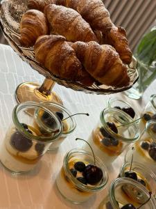 a table with a basket of croissants and a basket of bread at Humble Kro og Hotel in Humble +13 photos