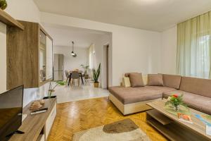 a living room with a couch and a table at Apartman Maria Pia in Lovran