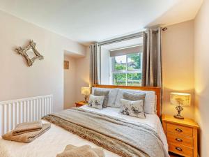 a bedroom with a bed with two pillows and a window at 2 Bed in Morpeth oc-cn049 in Acklington