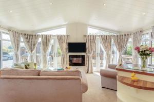 a living room with a couch and a fireplace at 2 Bed in Okehampton oc-80373 in Okehampton