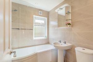 a bathroom with a tub and a sink and a toilet at 2 Bed in Okehampton oc-80373 in Okehampton +28 photos
