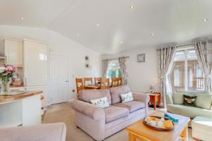 a living room with a couch and a table at 2 Bed in Okehampton oc-80373 in Okehampton