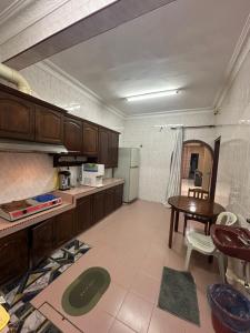 a large kitchen with a table and a refrigerator at Kapar Cozy Homestay in Kapar +22 photos