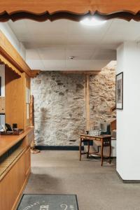 an office with a stone wall and a table at Hôtel du Glacier in Champex