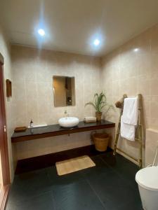 a bathroom with a sink and a mirror at Arunta Samui in Lipa Noi