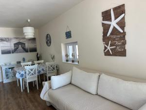 a living room with a couch and a dining room at Villa Sv. Martin in Mali Lošinj