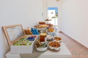 a table with various snacks and food on it at B&B Li Peticurti in Cerfignano