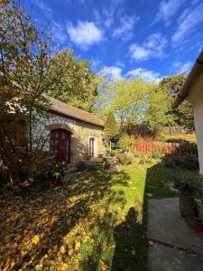 a small stone house in a yard with trees at Casa Szatina in Kishajmás +36 photos