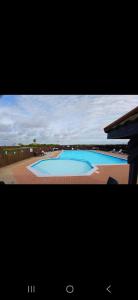 a television screen with a picture of a swimming pool at Steeple Bay E68 in Steeple