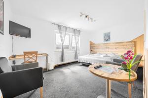 a living room with a bed and a table at Pension Domblick in Wetzlar