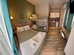 a small room with two beds and a kitchen at ΑVLI Sarti Studios & Apartments no 3 in Sarti