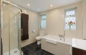 a bathroom with a shower and a toilet and a sink at Undercliff View - St Lawrence Retreat in Saint Lawrence +50 photos